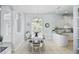 Light dining area with a modern chandelier, tile floors, views into the kitchen, and ample natural light at 212 Hazeltine Dr, Debary, FL 32713