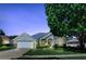 Charming single-story home with attached garage and a beautifully landscaped front yard at 212 Hazeltine Dr, Debary, FL 32713