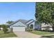 Beautiful single-Gathering home with manicured lawn, attached garage, and mature shade tree at 212 Hazeltine Dr, Debary, FL 32713