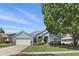 Charming single-Gathering home with a manicured lawn, attached garage, and beautiful landscaping at 212 Hazeltine Dr, Debary, FL 32713