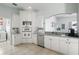 Bright kitchen with white cabinetry, stainless steel appliances, and a tile backsplash at 212 Hazeltine Dr, Debary, FL 32713