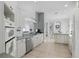 Clean and modern kitchen with white cabinetry, stainless steel appliances, and tile flooring at 212 Hazeltine Dr, Debary, FL 32713