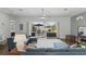 Bright living room featuring a ceiling fan, hardwood floors, and sliding glass doors to the patio and pool at 212 Hazeltine Dr, Debary, FL 32713