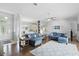 Bright living room with open layout, hardwood floors, and connection to the kitchen and dining room at 212 Hazeltine Dr, Debary, FL 32713
