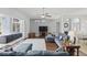 Spacious living room with hardwood floors, ceiling fan, and sliding glass doors to the outdoor living space at 212 Hazeltine Dr, Debary, FL 32713