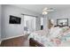 Cozy main bedroom features a ceiling fan, access to the balcony and en-suite bath at 212 Hazeltine Dr, Debary, FL 32713