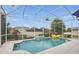 A sunny pool with screened enclosure and a fun inflatable duck. Lush landscaping surrounds the area at 212 Hazeltine Dr, Debary, FL 32713