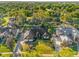 Aerial view of a charming home with lush landscaping, mature trees, and a well-manicured lawn in a quiet neighborhood at 216 Shady Oaks Cir, Lake Mary, FL 32746