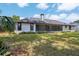 Back exterior view of a single-story house featuring a screened lanai with multiple skylights at 216 Shady Oaks Cir, Lake Mary, FL 32746