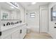Modern bathroom featuring double sinks, white cabinets, and updated fixtures at 216 Shady Oaks Cir, Lake Mary, FL 32746