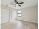Bright bedroom featuring light wood flooring, a ceiling fan, and a large closet with sliding doors at 216 Shady Oaks Cir, Lake Mary, FL 32746