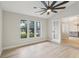 Bright bedroom with hardwood floors, large windows, and a modern ceiling fan at 216 Shady Oaks Cir, Lake Mary, FL 32746