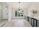 Dining room featuring a modern chandelier, light wood flooring, and wine bar with a drink refrigerator at 216 Shady Oaks Cir, Lake Mary, FL 32746