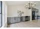 Dining room featuring a modern chandelier, light wood flooring, and wine bar with a drink refrigerator at 216 Shady Oaks Cir, Lake Mary, FL 32746