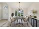 Staged dining room featuring a modern chandelier, dining table, and wine bar with a drink refrigerator at 216 Shady Oaks Cir, Lake Mary, FL 32746