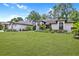 Charming home showcasing a pristine lawn, mature trees, and a freshly painted white brick exterior at 216 Shady Oaks Cir, Lake Mary, FL 32746