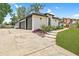 Spacious three-car garage, white brick exterior, with a concrete driveway and lush green landscaping at 216 Shady Oaks Cir, Lake Mary, FL 32746
