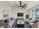 Cozy living room featuring comfortable furniture, a blue accent rug, and plenty of natural light at 216 Shady Oaks Cir, Lake Mary, FL 32746