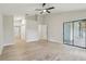 Spacious living room featuring light wood floors, large sliding door, and ceiling fan at 216 Shady Oaks Cir, Lake Mary, FL 32746
