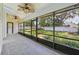 Relaxing screened patio featuring tile floors, ceiling fans, and view of backyard at 216 Shady Oaks Cir, Lake Mary, FL 32746