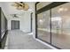 Enclosed patio featuring ceiling fans, slate floors, and large sliding glass doors to seamlessly blend indoor and outdoor living at 216 Shady Oaks Cir, Lake Mary, FL 32746