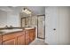 This bathroom features a double vanity, granite countertops, and a spacious shower with glass door at 2167 Velvet Leaf Dr, Ocoee, FL 34761