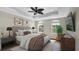 Staged bedroom showcasing neutral walls, tray ceiling, wood floors, and natural light at 2167 Velvet Leaf Dr, Ocoee, FL 34761