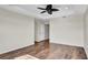 Bright bedroom featuring wood floors and a tray ceiling with fan at 2167 Velvet Leaf Dr, Ocoee, FL 34761