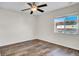 This bedroom has wood-look floors, a ceiling fan with lights, and a window at 2167 Velvet Leaf Dr, Ocoee, FL 34761
