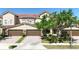 Beautiful townhome featuring a red tile roof, brown garage doors, and a paver driveway at 2167 Velvet Leaf Dr, Ocoee, FL 34761