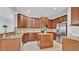 Modern kitchen with stainless steel appliances, center island, and granite countertops at 2167 Velvet Leaf Dr, Ocoee, FL 34761