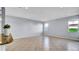 Open-concept living space with tile flooring, large windows, and neutral wall paint at 2167 Velvet Leaf Dr, Ocoee, FL 34761