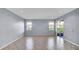 Expansive living room with neutral tile flooring and abundant natural light from windows and slider at 2167 Velvet Leaf Dr, Ocoee, FL 34761