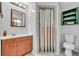 Bathroom featuring a single vanity, standard toilet, decorative shower stall, and natural light at 217 E Hillcrest St, Altamonte Springs, FL 32701