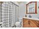 Nicely renovated bathroom with a modern vanity, stylish fixtures, and a shower with patterned curtain at 217 E Hillcrest St, Altamonte Springs, FL 32701