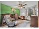 Charming bedroom with green accent wall, crib, changing table, ceiling fan, and natural light from the windows at 217 E Hillcrest St, Altamonte Springs, FL 32701
