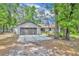 Charming single-story home with a two-car garage, a basketball hoop and a spacious driveway, nestled among mature trees at 217 E Hillcrest St, Altamonte Springs, FL 32701