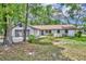 Single-story home with light gray siding, brick accents, blue front door, and a well-maintained lawn at 217 E Hillcrest St, Altamonte Springs, FL 32701