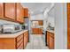 Well-lit kitchen featuring wood cabinets, stainless steel appliances, and granite countertops at 217 E Hillcrest St, Altamonte Springs, FL 32701