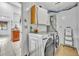 Functional laundry room with a washer, dryer, storage cabinets, and easy access to the kitchen at 217 E Hillcrest St, Altamonte Springs, FL 32701