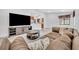Open living room featuring a large sectional sofa, modern entertainment center, and seamless flow to the kitchen at 217 E Hillcrest St, Altamonte Springs, FL 32701