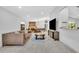 Spacious living area with a fireplace, dining table, and open layout to the kitchen at 217 E Hillcrest St, Altamonte Springs, FL 32701