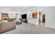 Spacious living room with a large television, breakfast bar to the kitchen, and dining area with a wood feature wall at 217 E Hillcrest St, Altamonte Springs, FL 32701