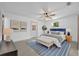 Bright main bedroom with neutral décor, featuring a ceiling fan, bench, and an inviting accent rug at 217 E Hillcrest St, Altamonte Springs, FL 32701