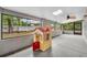 Enclosed patio with windows, skylight, and playful playhouse at 217 E Hillcrest St, Altamonte Springs, FL 32701