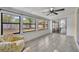 Bright sunroom features large windows with backyard views, tile floors, and a ceiling fan at 217 E Hillcrest St, Altamonte Springs, FL 32701