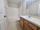 Bathroom with wood vanity, tile floor, shower and tub combo at 224 Lake Charles Dr, Davenport, FL 33837