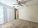 Bedroom with closet, carpeted floor and ceiling fan at 224 Lake Charles Dr, Davenport, FL 33837
