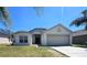 Charming single Gathering home featuring an attached two car garage and a well maintained lawn at 224 Lake Charles Dr, Davenport, FL 33837