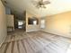Bright living room featuring carpet flooring, natural light, and open to the kitchen at 224 Lake Charles Dr, Davenport, FL 33837